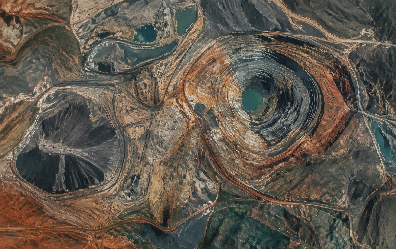 Aerial view of terraced mineral geology and mine infrastructure